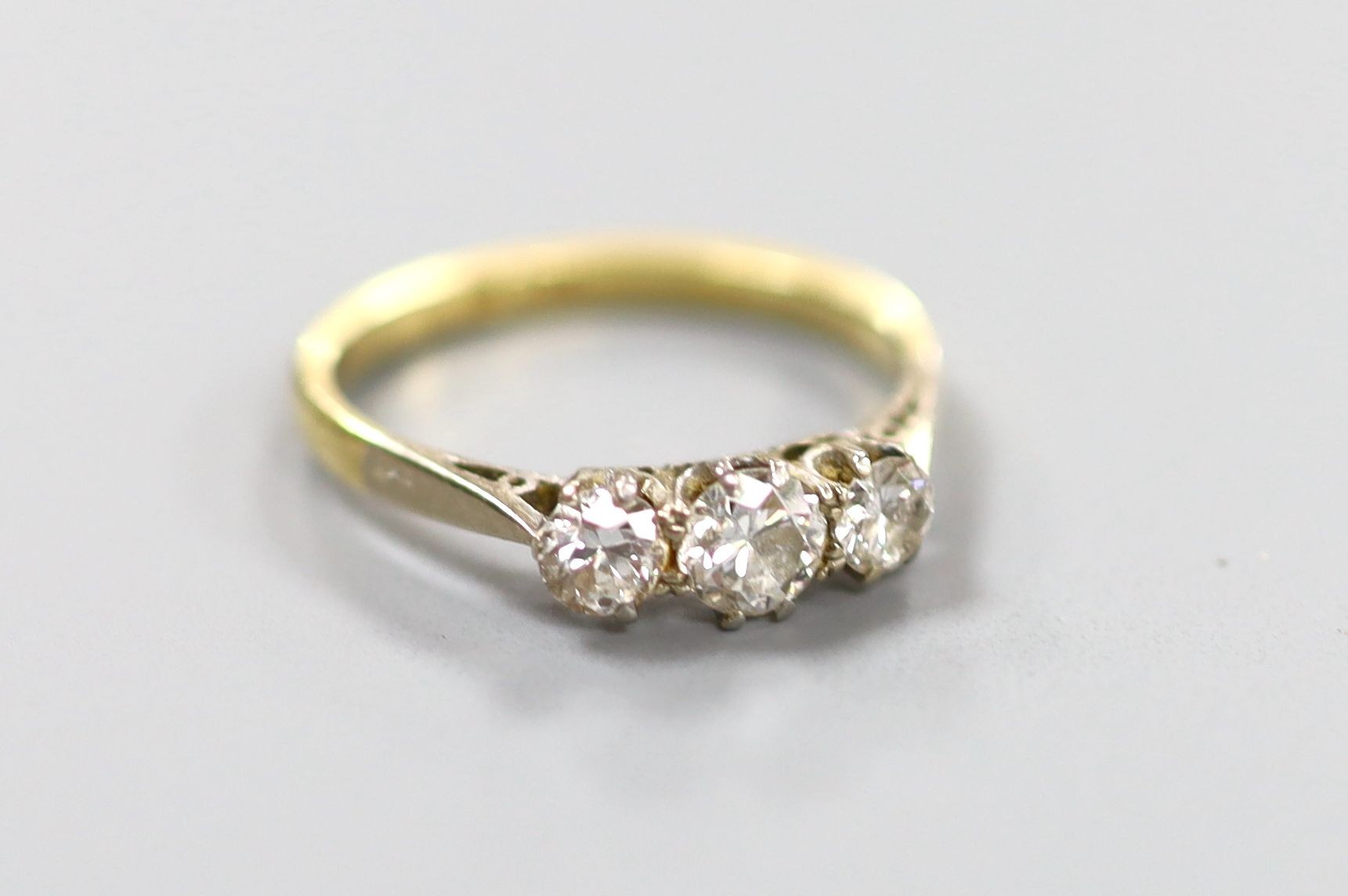An 18ct & Pt, three stone diamond ring, size M, gross 2.4 grams.
